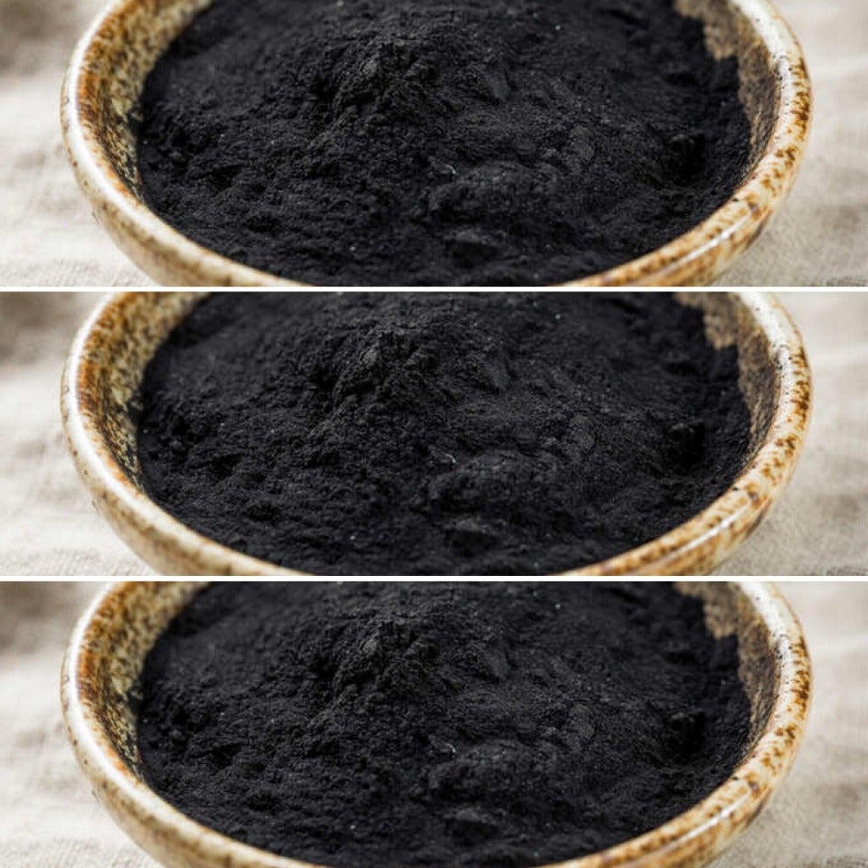 Ceramic bowls of activated charcoal ingredient ready to use in soap and shampoo bars