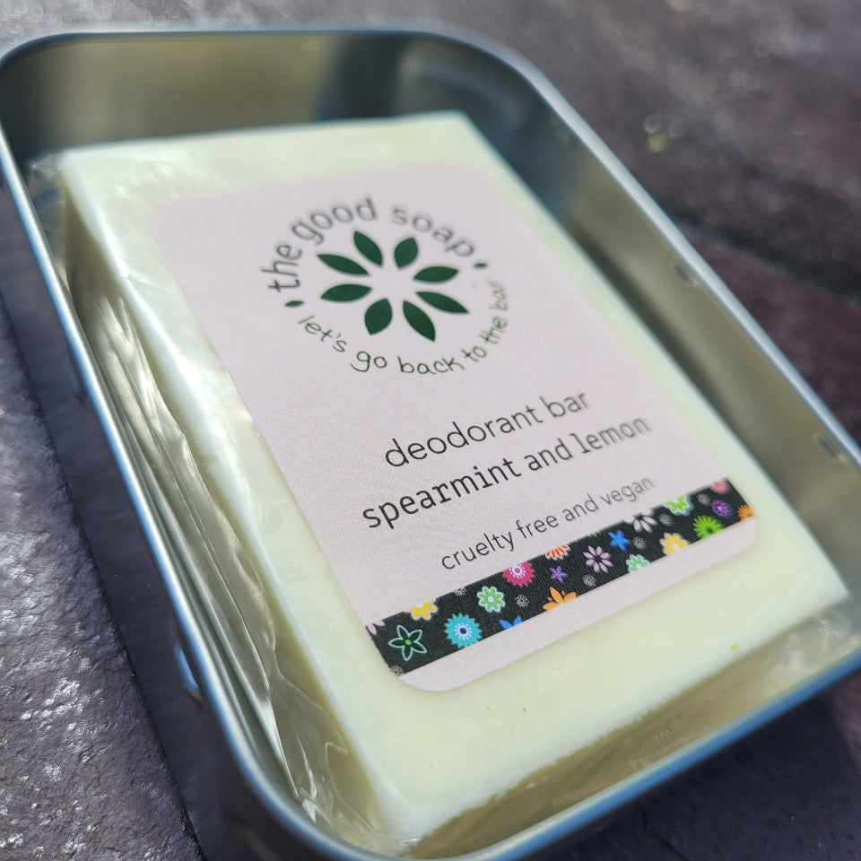 A spearmint and lemon solid natural deodorant bar in a storage tin