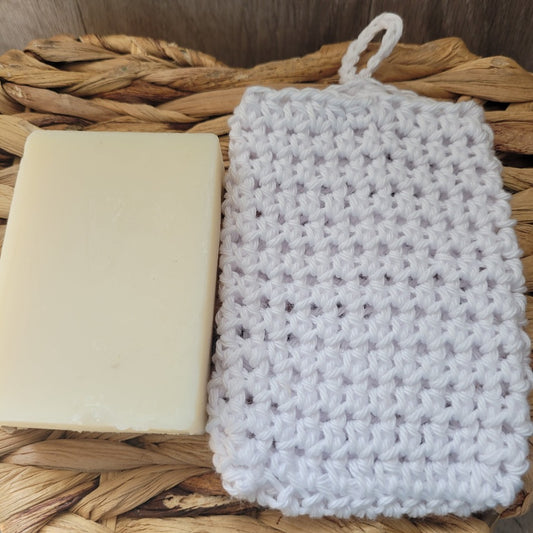 A soap bar with a crocheted soap saver bag