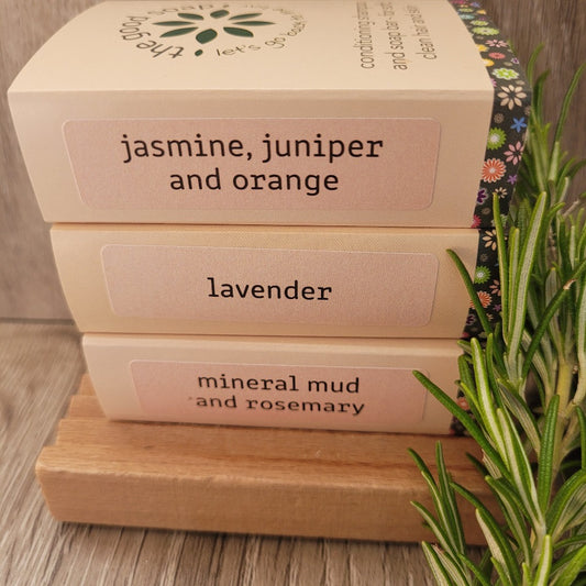 Trio of 3 Floral Scented Soap Bars on a wooden soap dish with a sprig of rosemary