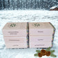 Stack of scented soaps with labels in a snowy landscape