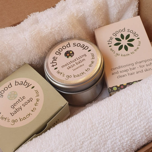 Gift for mother and baby, contains The Good Baby Soap, moisturising lavender skin balm, an aloe vera shampoo bar, a white towel and a white flannel