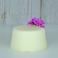 A natural baby soap on a wooden background, decorated by a pretty purple flower