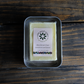 A solid and natural deodorant bar in a storage tin. Deodorant bar is contained in compostable packaging