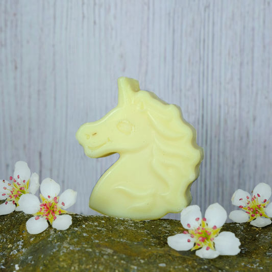 Sparkle Unicorn Children's Soap and Shampoo bar on a stone background with pretty white flowers